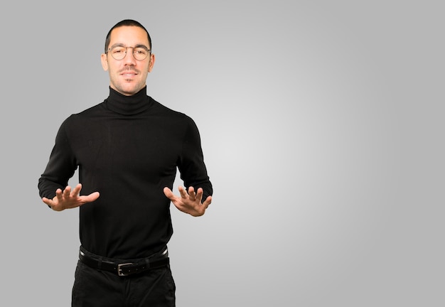 Friendly young man doing a gesture of keep calm