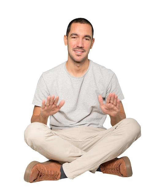 Friendly young man doing a gesture of keep calm