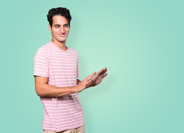 Friendly young man doing a gesture of keep calm