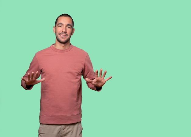 Friendly young man doing a gesture of keep calm