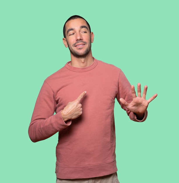 Friendly young man doing a gesture of keep calm