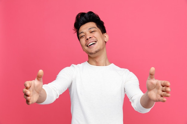 Friendly young man doing welcome gesture 