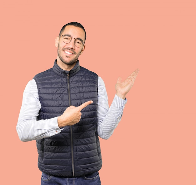 Friendly young man making a gesture of welcome