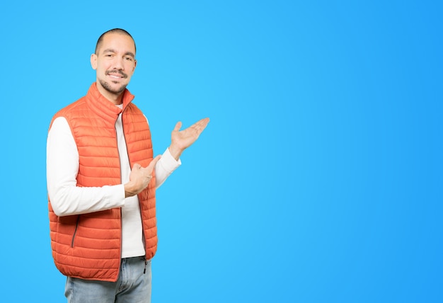 Friendly young man making a gesture of welcome