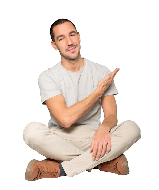 Friendly young man making a gesture of welcome