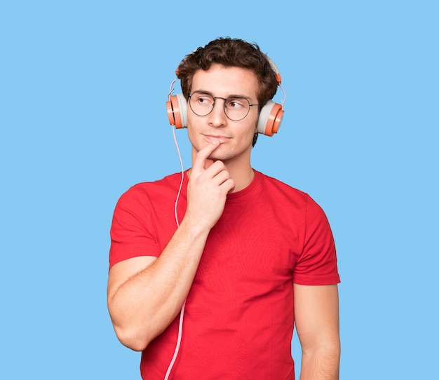 Friendly young man making a wondering gesture