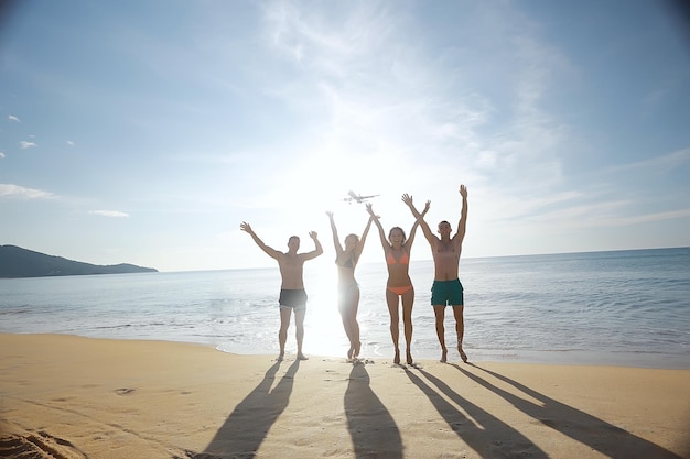 Friends on the beach summer by the sea / cheerful company of\
young friends, summer view