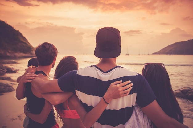 Friends on beach at sunset