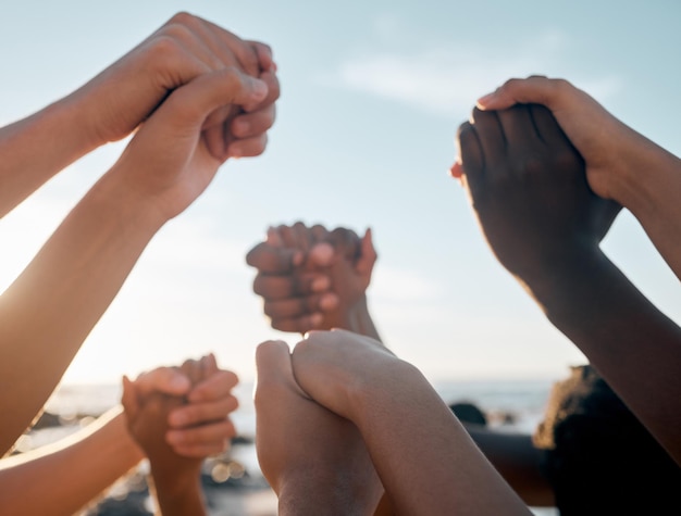 Photo friends bonding and holding hands on beach community trust support social gathering or summer holiday success men women and diversity people in solidarity team building or travel mission goals
