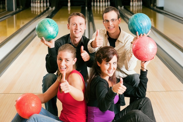 Friends bowling together