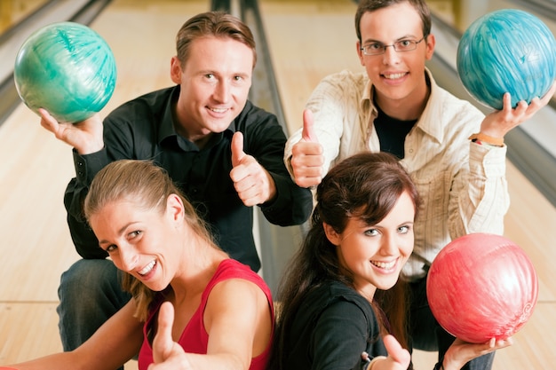 Friends bowling together