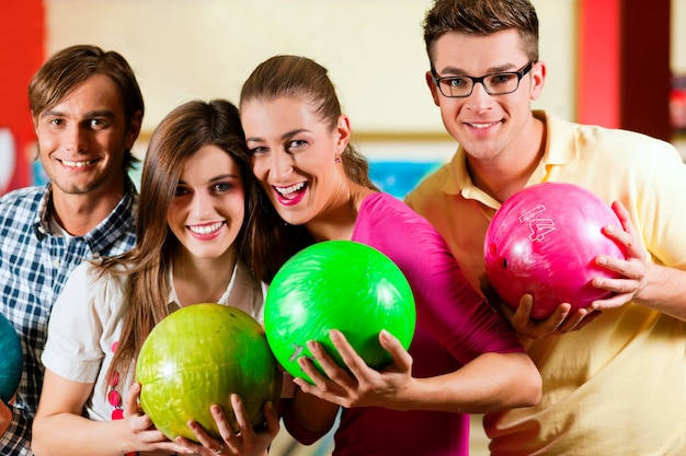 Friends bowling together