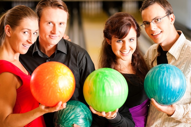 Friends bowling together