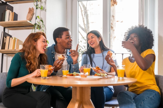 Friends at a breakfast with orange juice and muffins at home together to celebrate good news