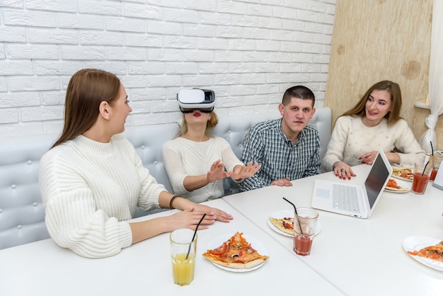 Friends in cafe making fun with virtual glasses