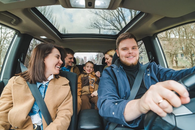 friends in car with little kid car travel concept