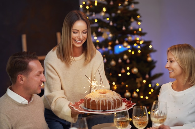 Friends celebrating christmas party holding wine. High quality photo