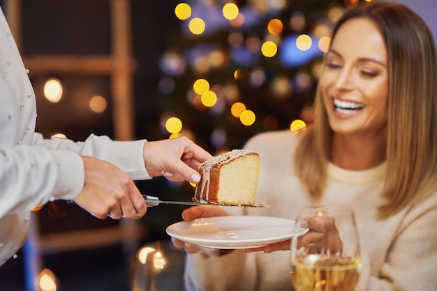 Friends celebrating christmas party holding wine. High quality photo