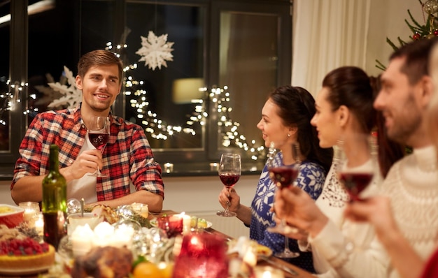 friends celebrating christmas and speaking toast
