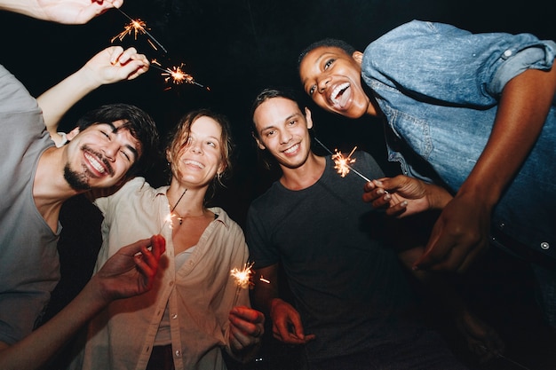 friends celebrating with sparklers in the night
