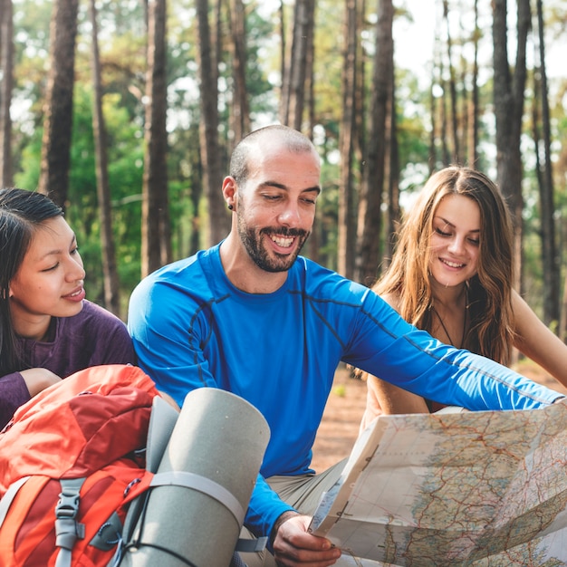 Friends checking map outdoors concept