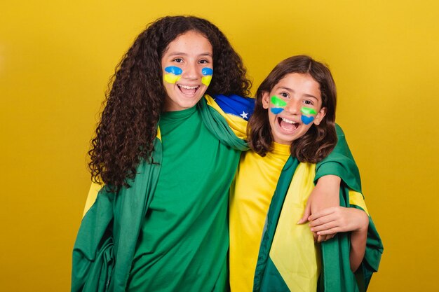 Friends cheering from Brazil soccer fans hugging smiling and cheering for a soccer game World Cup Olympics