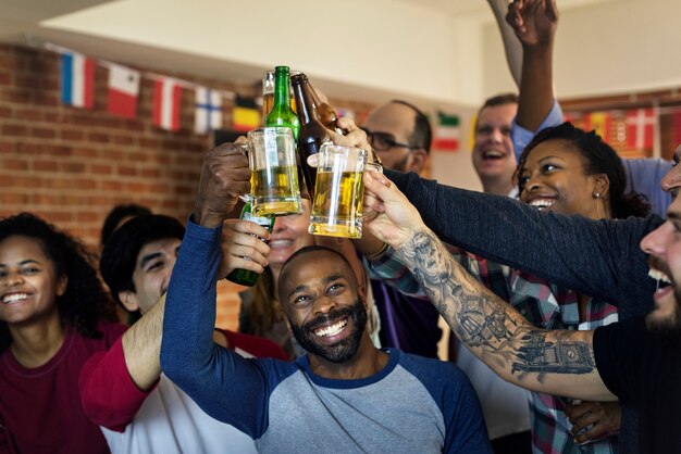 Friends cheering sport at bar together