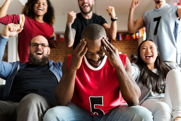 Friends cheering sport league together