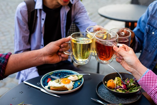 Friends cheering up with glases of drink