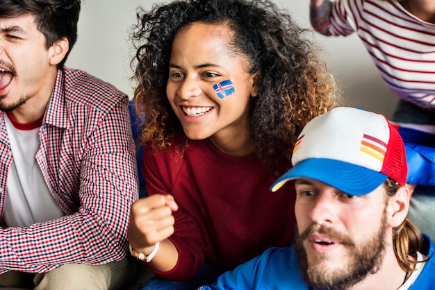 Friends cheering world cup with painted flag