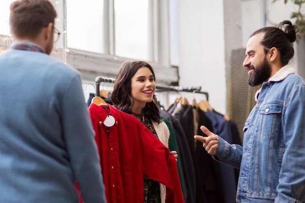 friends choosing clothes at vintage clothing store