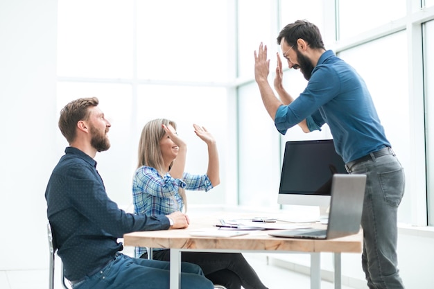 Friends coworkers giving each other a high five