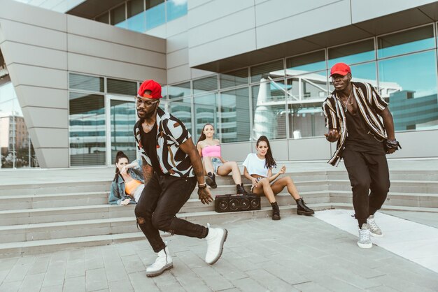 Friends dancing against building in city