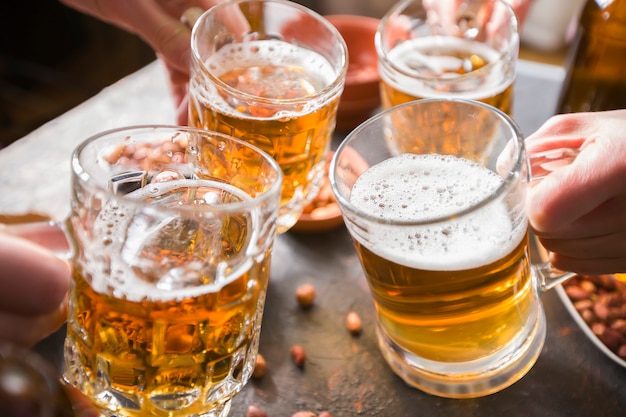 Friends drinking beer in a bar