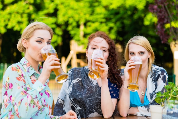 Friends drinking in beer garden restaurant