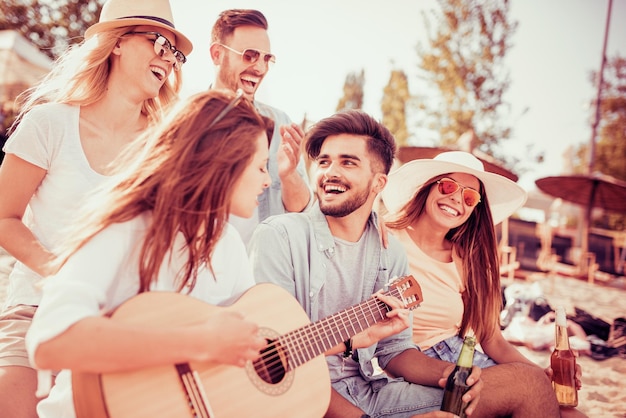 Friends drinking beers and listening to music