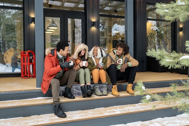 Friends drinking coffee in winter morning