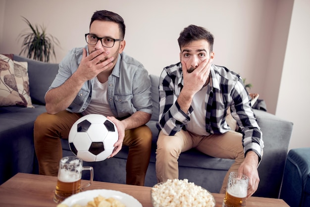 Friends enjoying soccer on TV