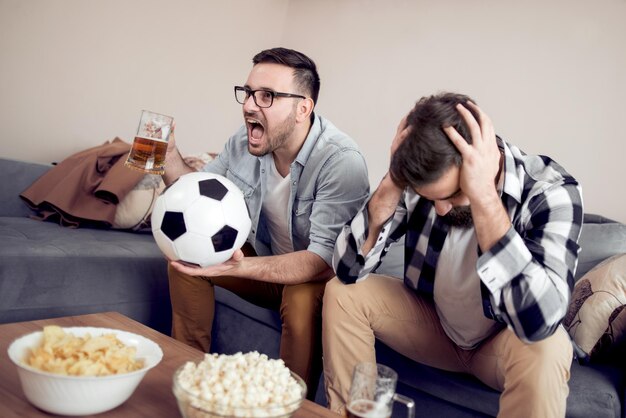 Friends enjoying soccer on TV