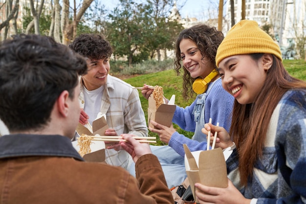 Friends from diverse cultures enjoy noodles and laughter