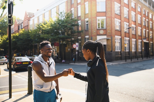 Friends giving a fist bump in London