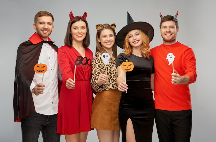 Photo friends in halloween costumes with party props