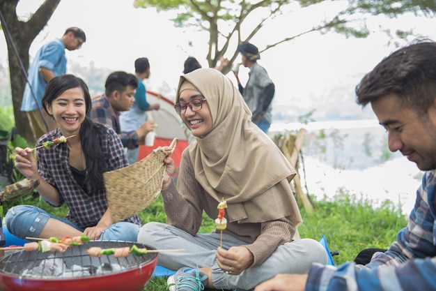 Friends having barbecue together