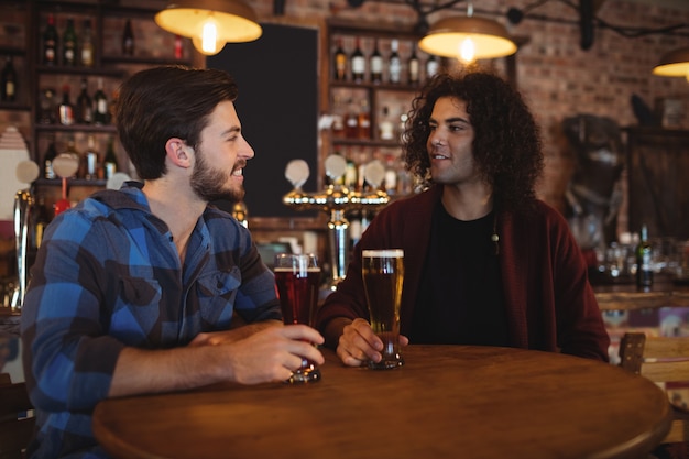 Friends having beer in pub