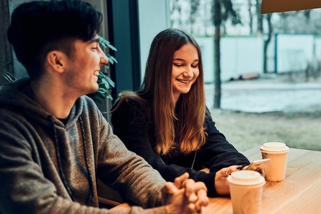 friends having a chat talking together drinking coffee sitting in a cafe