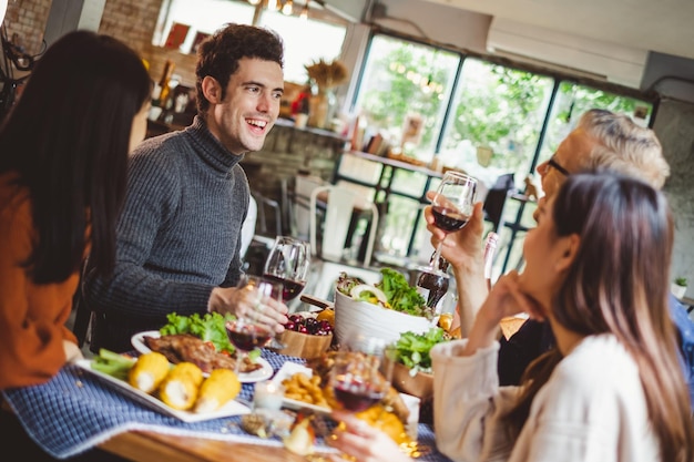 Foto amici che mangiano e bevono al ristorante