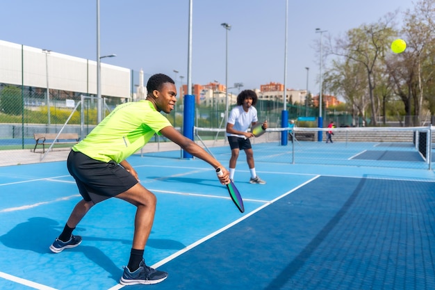 Friends having fun during pickleball match outdoors