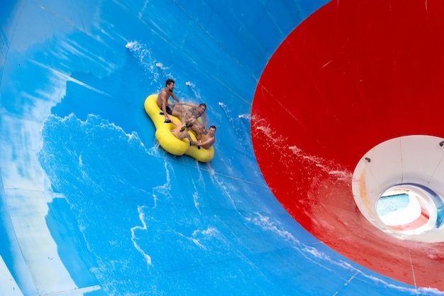 Friends having fun sliding in a big water slide