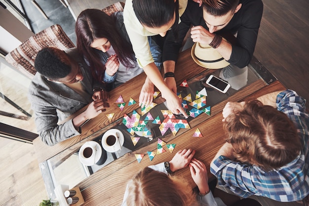 Photo friends having fun while playing board game