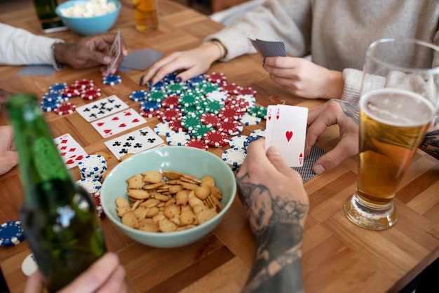 Photo friends having fun while playing poker